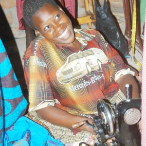 a woman sitting on a chair sewing